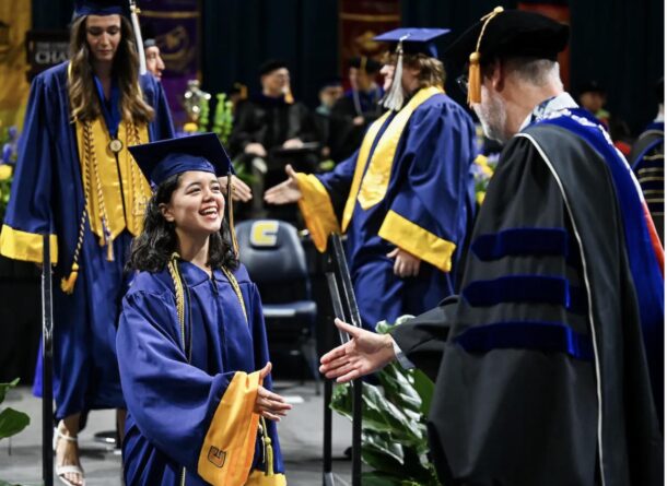 Mara Doze shakes hands with Interim Chancellor Robert Dooley during UTC’s commencement ceremonies.